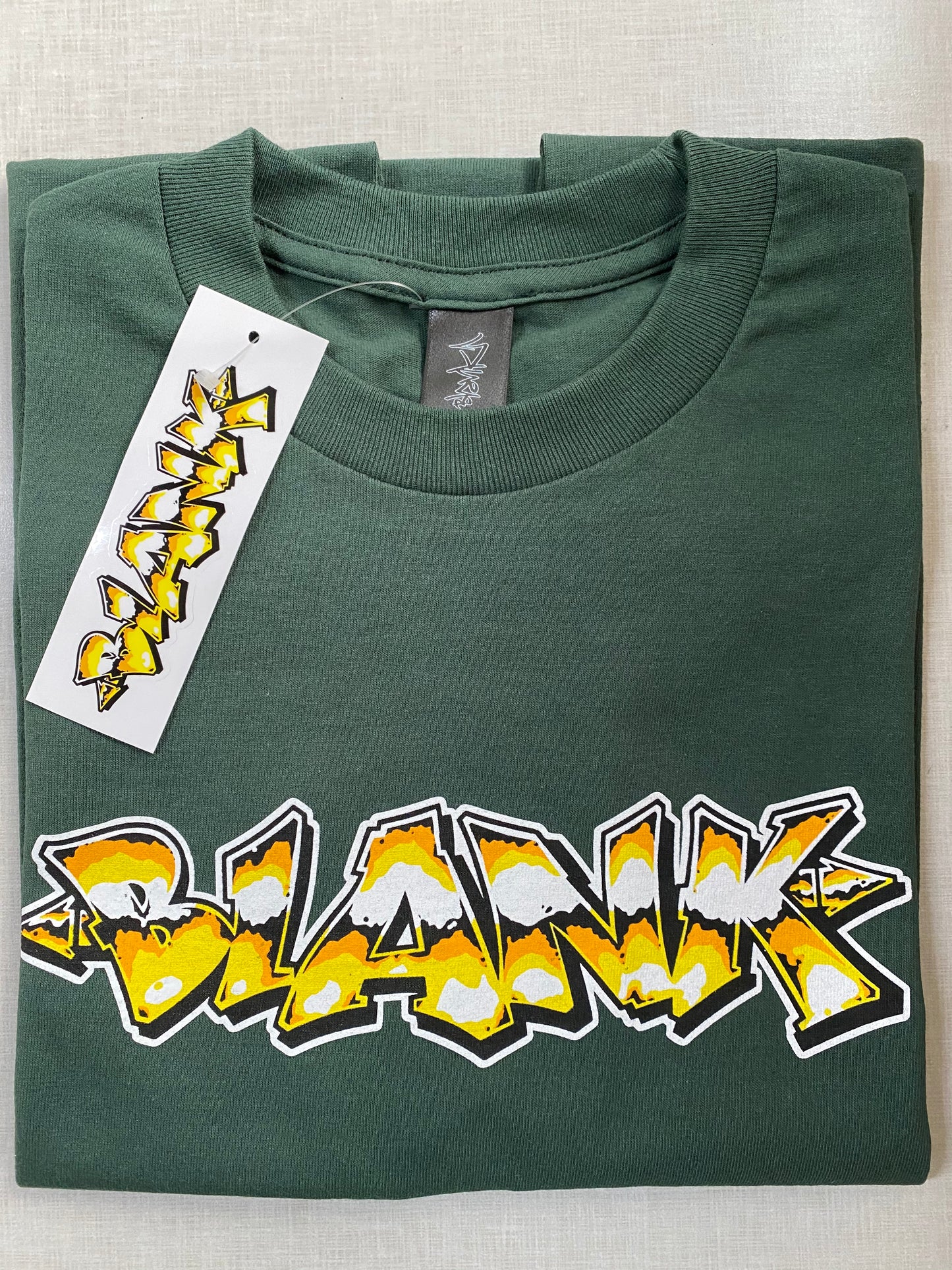 Goldie green graphic tee featuring in-house artwork by Blank TM