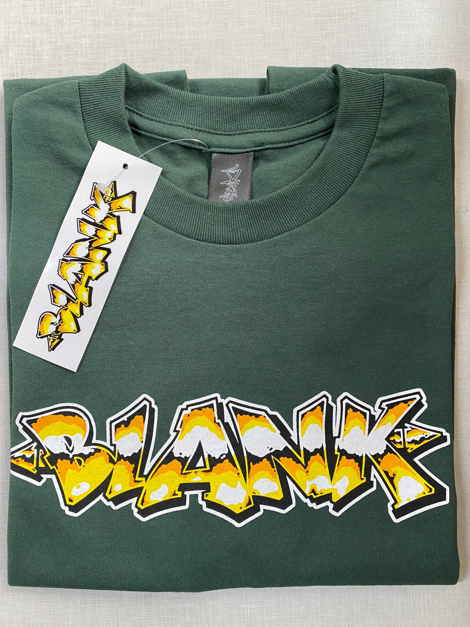 Goldie green graphic tee featuring in-house artwork by Blank TM